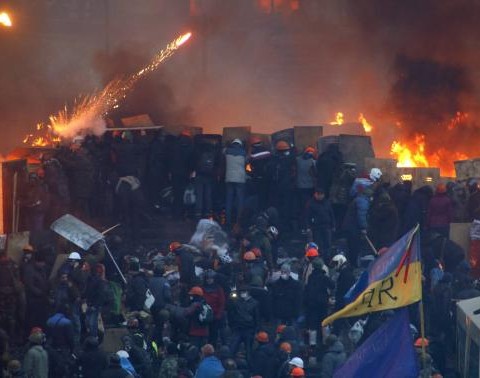 Anti-government protesters clash with riot police at Independence Square in Kiev